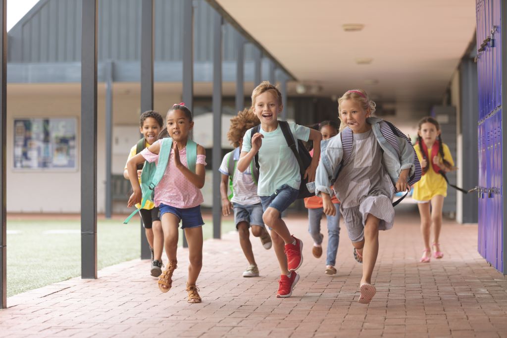 Kids running from school looking happy