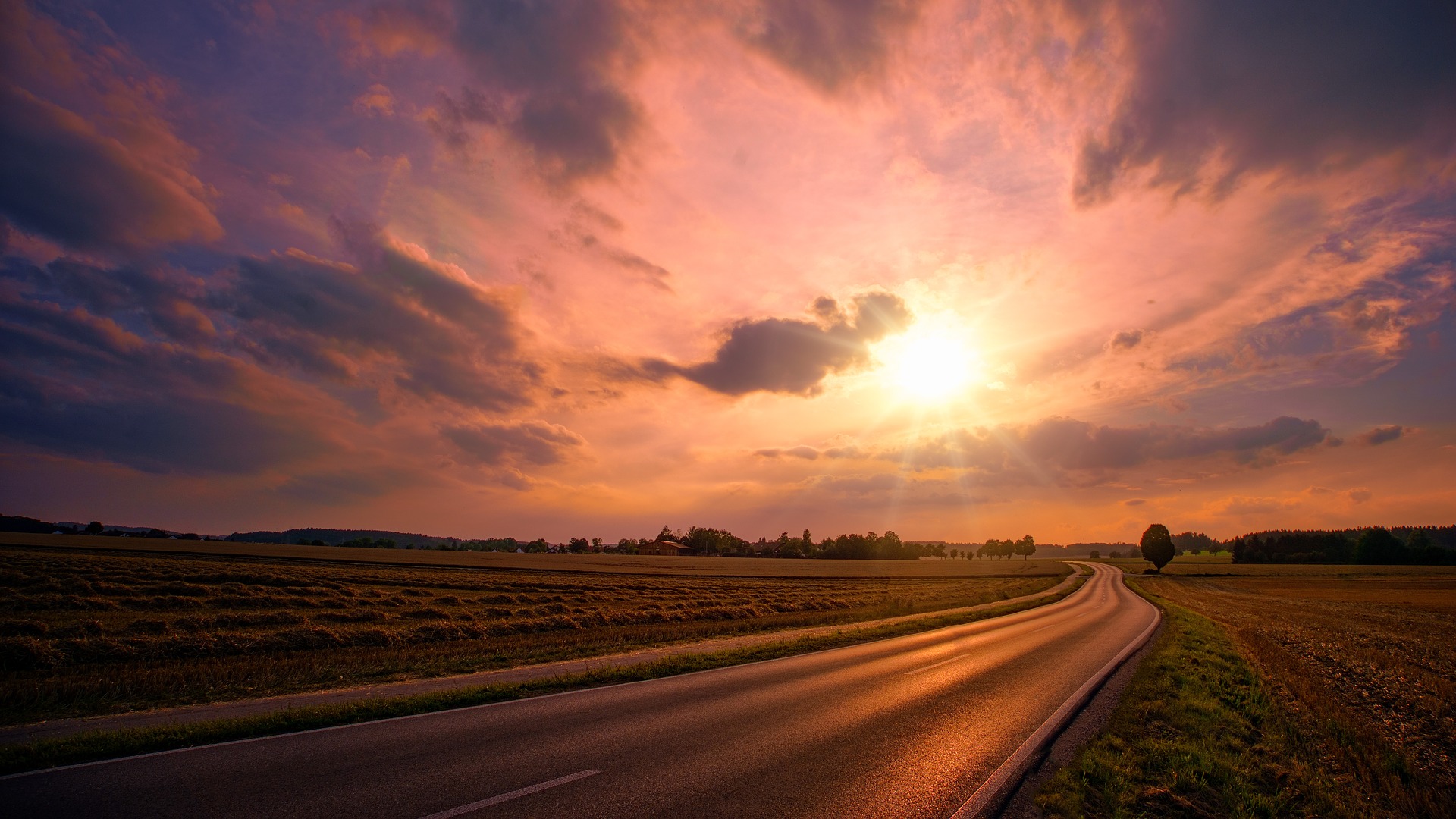 A road stretching out into the sunset.