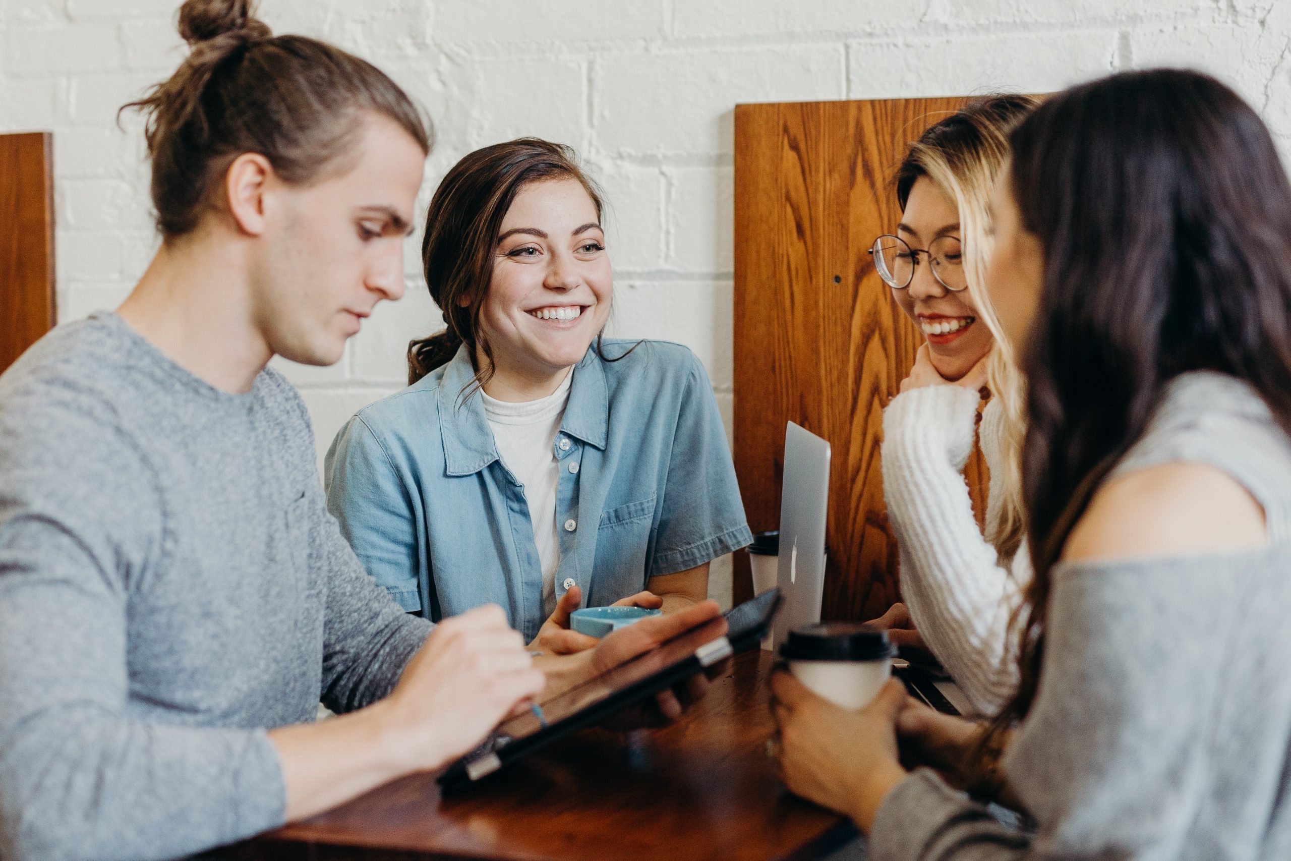 A group of people work together at a table.