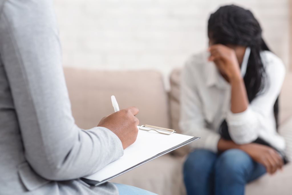 Two women engage in a therapy session